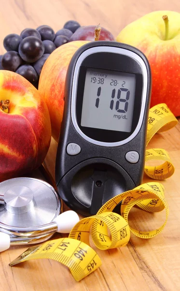 Glucose meter with medical stethoscope and fresh fruits, healthy lifestyle
