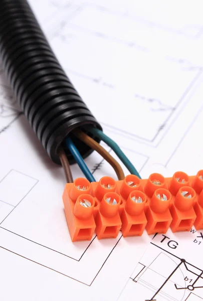 Corrugated pipe and electrical cable with connection cube on drawing — Stock Photo, Image