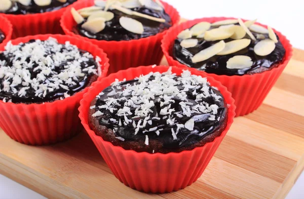 Chocolate muffins with desiccated coconut and sliced almonds — Stock Photo, Image