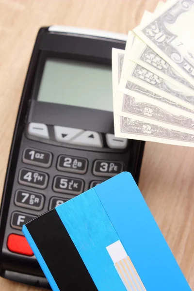 Currencies dollar with credit card and payment terminal in background, finance concept — Φωτογραφία Αρχείου