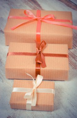 Vintage photo, Wrapped gifts for Christmas or other celebration on old wooden background