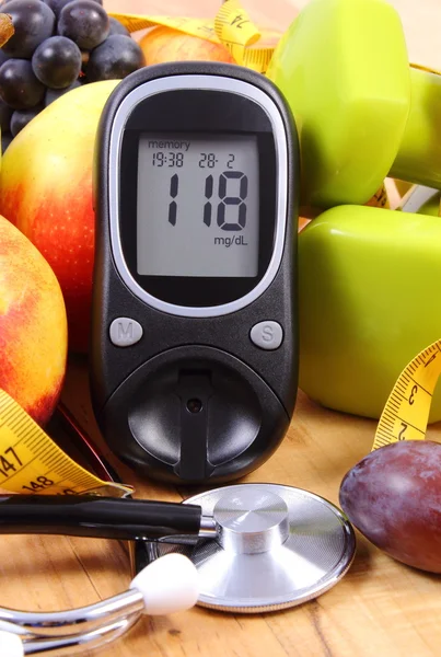 Glucose meter with medical stethoscope, fruits and dumbbells for using in fitness — Stock Photo, Image