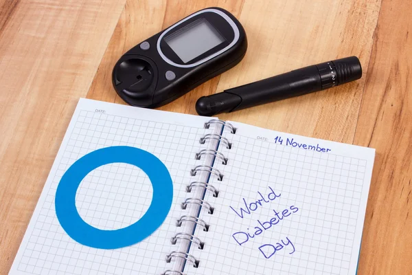 Glucometer, dia de diabetes mundial escrito em caderno e círculo azul, símbolo de diabético — Fotografia de Stock