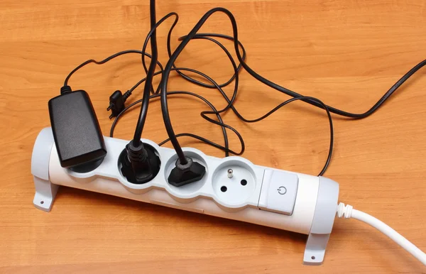 Electrical cords connected to power strip, energy saving — Stock Photo, Image