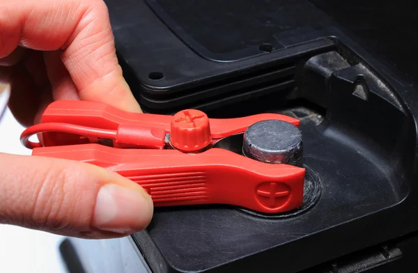 Hand of woman and car battery charging — Stock Photo, Image