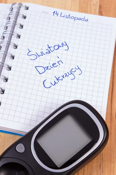 Glucometer e polimento inscrição mundo diabetes dia no notebook — Fotografia de Stock