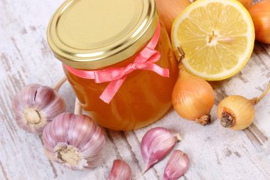 Honey in glass jar, onion, lemon and garlic, healthy nutrition and strengthening immunity