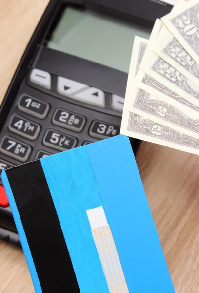 Currencies dollar with credit card and payment terminal in background, finance concept — Φωτογραφία Αρχείου