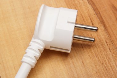 Electrical plug on wooden floor