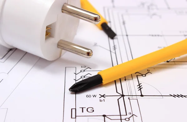Screwdriver and electric plug on construction drawing — Stock Photo, Image