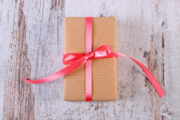 Wrapped gift for Valentines day on old wooden table — ストック写真