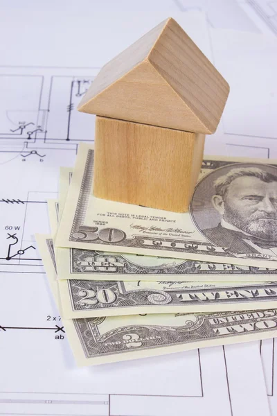 House of wooden blocks and currencies dollar on construction drawing, building house concept Stock Photo