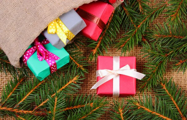 Inslagna presenter i kasse av jute till jul eller andra firande och spruce grenar — Stockfoto