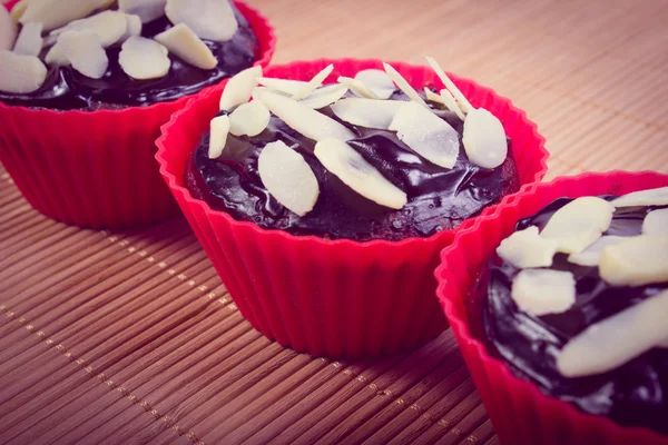 Vintage photo, Fresh baked chocolate muffins with sliced almonds — Stock Photo, Image