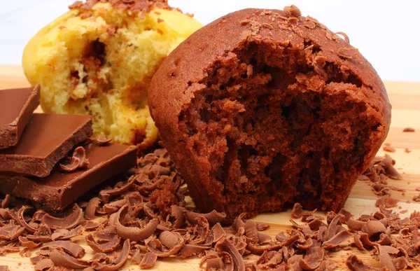 Fresh baked muffins, grated and portion of chocolate — Stock Photo, Image