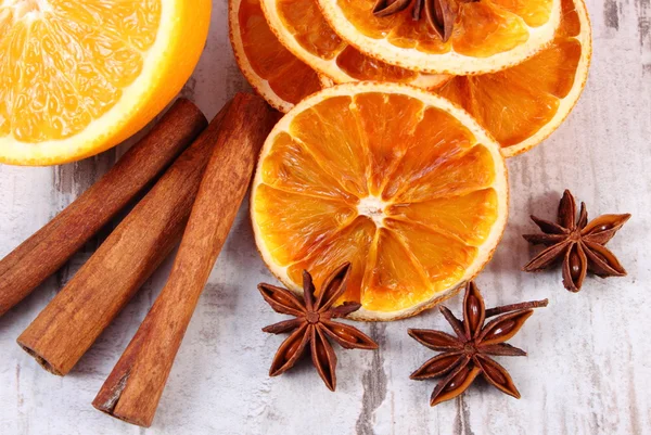 Gedroogde en verse oranje met specerijen op oude houten achtergrond — Stockfoto