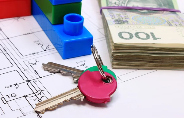Keys, heap of banknotes and building blocks on drawing of house — Stock Photo, Image