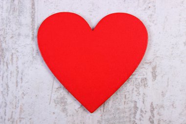 Valentine red heart on old wooden white table, symbol of love