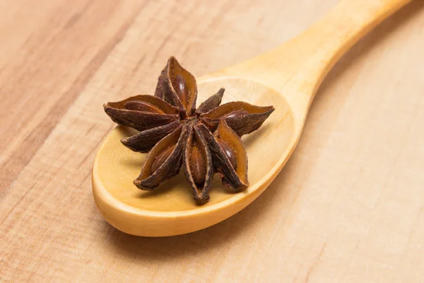 Sternanis mit Kochlöffel auf Holztisch, Gewürz zum Kochen — Stockfoto