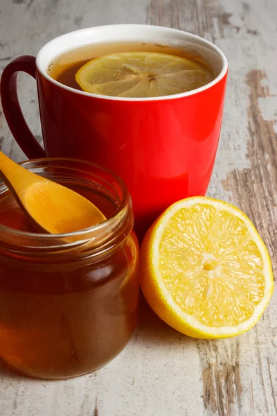 Fresh lemon, honey and cup of tea on wooden table, healthy nutrition — 스톡 사진