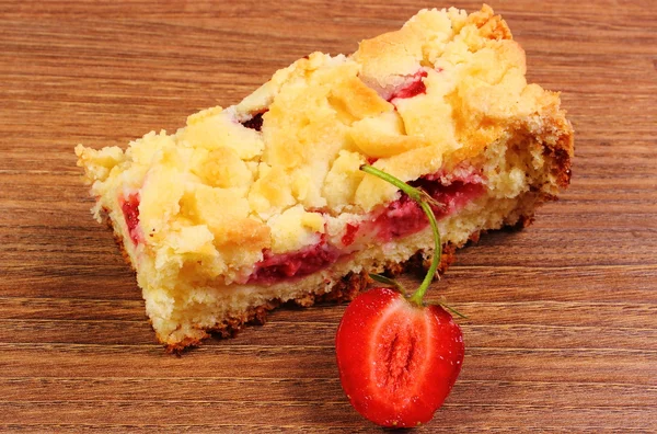 Fresh baked yeast cake with strawberries on wooden table — Stock Photo, Image