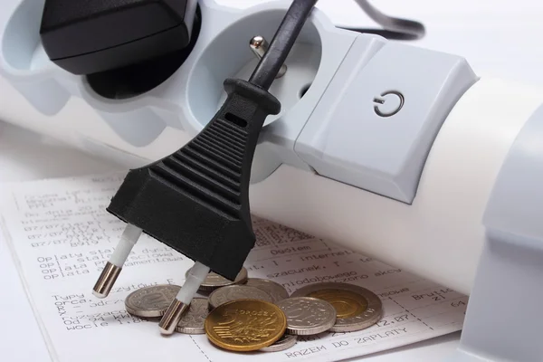 Electrical cords disconnected from power strip, electricity bill — Stock Photo, Image