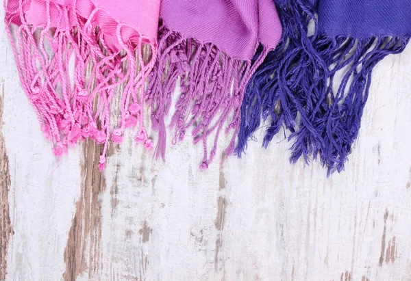Colorful scarves with copy space for text, old rustic wooden background — Zdjęcie stockowe