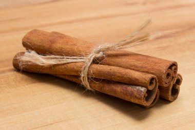 Cinnamon sticks on wooden table, seasoning for cooking
