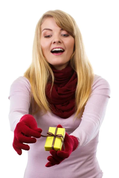 Smiling woman in woolen gloves opening gift for Christmas or other celebration — Zdjęcie stockowe