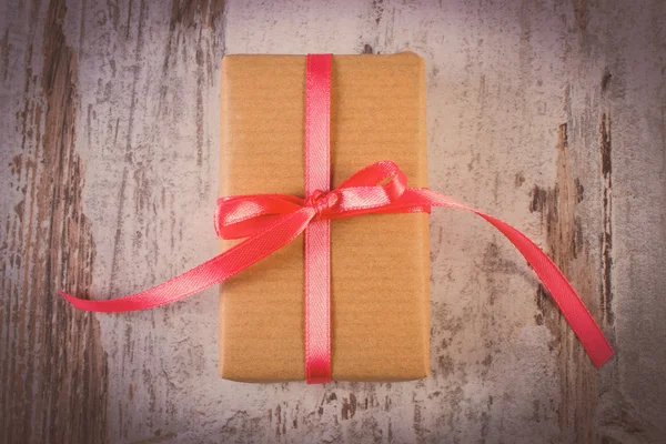 Vintage photo, Wrapped gift for Valentines day on old wooden table — Stockfoto
