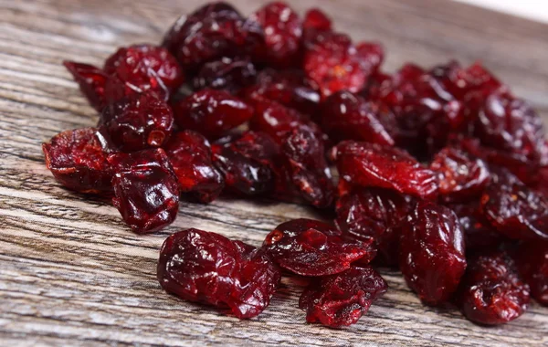 Heap of red cranberries on wooden table — Stock Photo, Image