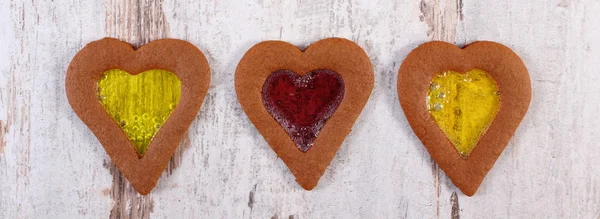 Stained glass gingerbread on old wooden background, christmas time — Stock Photo, Image