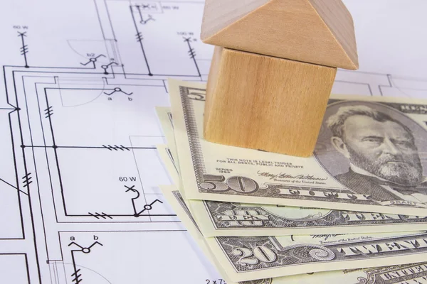 House of wooden blocks and currencies dollar on construction drawing, building house concept Stock Image