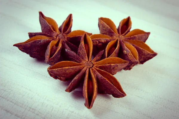 Vintage photo, Star anise spice on white wooden table — Stock fotografie