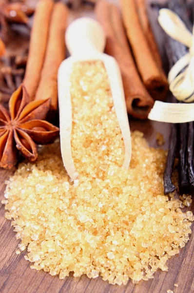 Sugar cane, vanilla, cinnamon sticks and star anise on wooden surface plank — Stockfoto