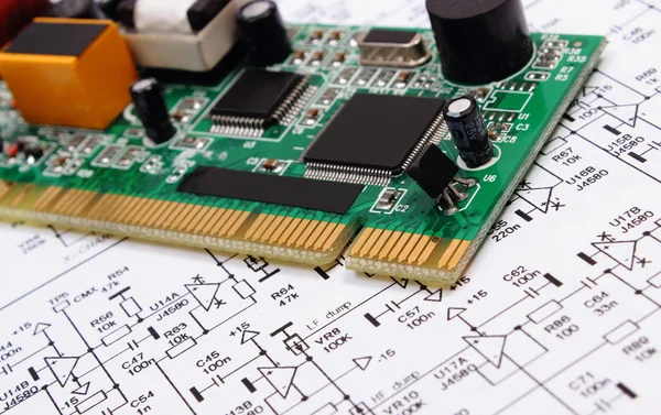 Printed circuit board lying on diagram of electronics, technology — Stock Photo, Image