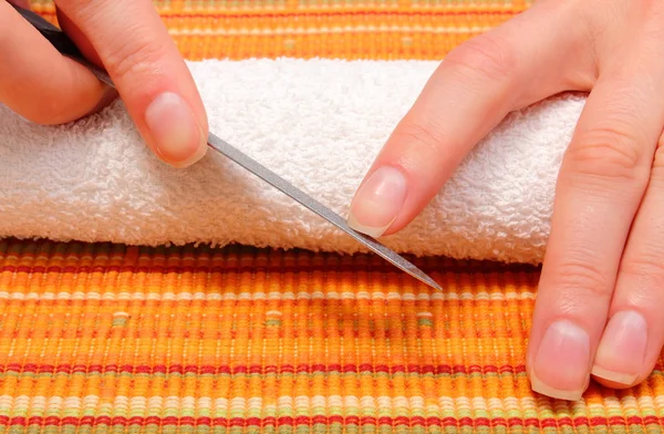 Woman polishing fingernails with nail file — Stock Photo, Image