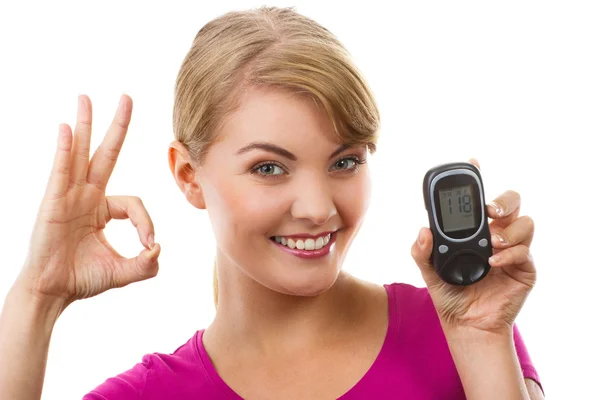 Woman holding glucometer and showing sign ok, checking and measuring sugar level, concept of diabetes — Stock Photo, Image