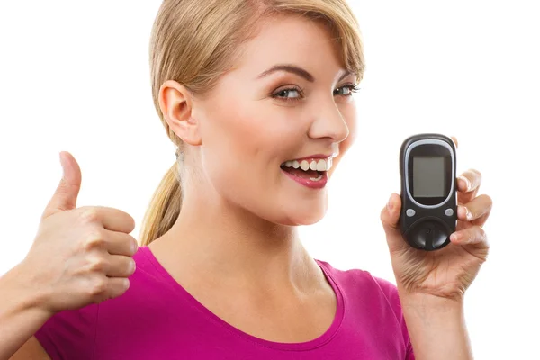 Woman holding glucometer and showing thumbs up, checking and measuring sugar level, concept of diabetes — Stock Photo, Image