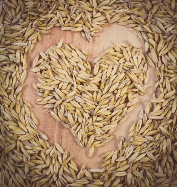 Vintage photo, Heart of oat grains, healthy nutrition, symbol of love — Stock Photo, Image