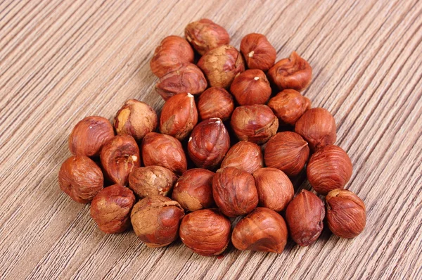 Heart of brown hazelnut on wooden table — ストック写真