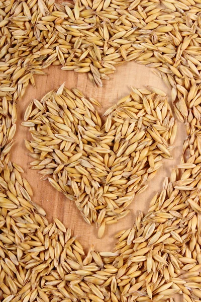 Heart of oat grains, healthy nutrition, symbol of love — Stock Photo, Image