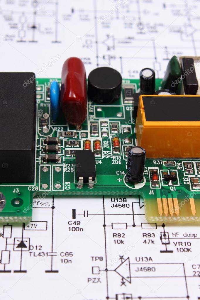 Printed circuit board lying on diagram of electronics, technology 