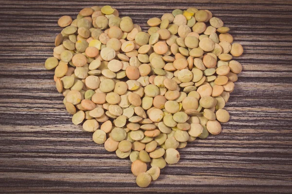 Vintage photo, Heart of green lentil on wooden background — 스톡 사진