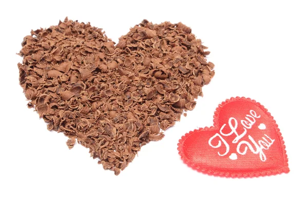 Heart shaped grated chocolate on white background — Stock Photo, Image