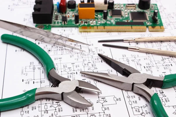 Printed circuit board and precision tools on diagram of electronics, technology — Stock Photo, Image