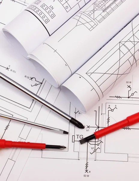 Rolls of diagrams and work tools on electrical construction drawing of house Royalty Free Stock Photos