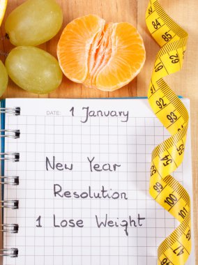 Yeni yıl kararları yazılı defter ve şerit metre