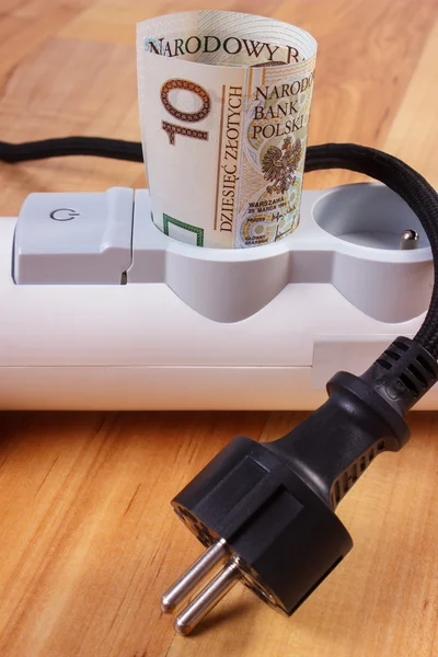 Rolls of polish currency money in electrical power strip and disconnected plug, energy costs — Stock Photo, Image