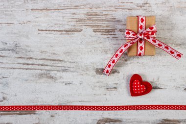 Wrapped gift, red heart with ribbon for Valentines Day, copy space for text